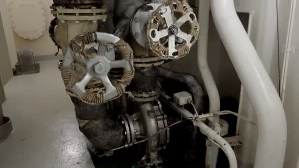 Pipelines twist in machinery room close low angle shot — Stock Video