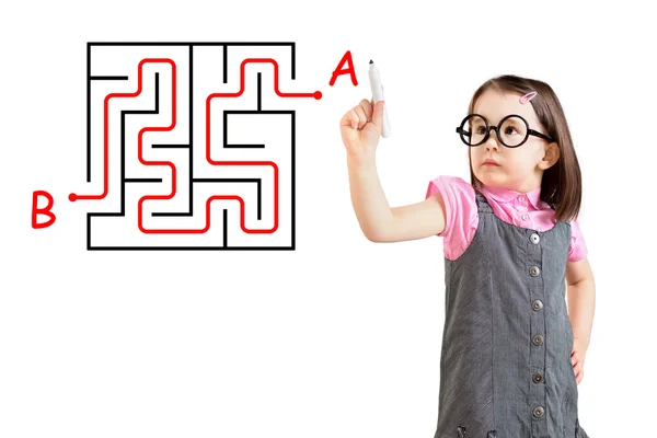 Cute little girl wearing business dress and finding the maze solution writing on the whiteboard. White background. — Stock Photo, Image