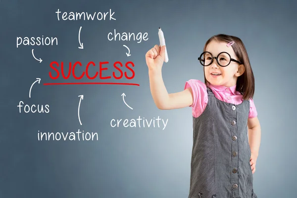 Cute little girl wearing business dress and writing success diagram on glass board with marker. Blue background. — Stock Photo, Image