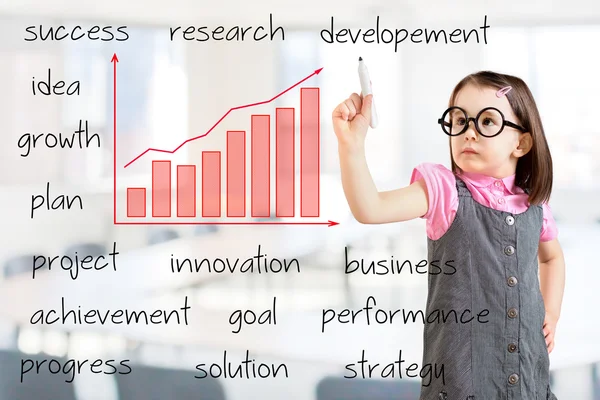 Cute little girl wearing business dress and writing growth graph with business related text. Office background. — Stock Photo, Image