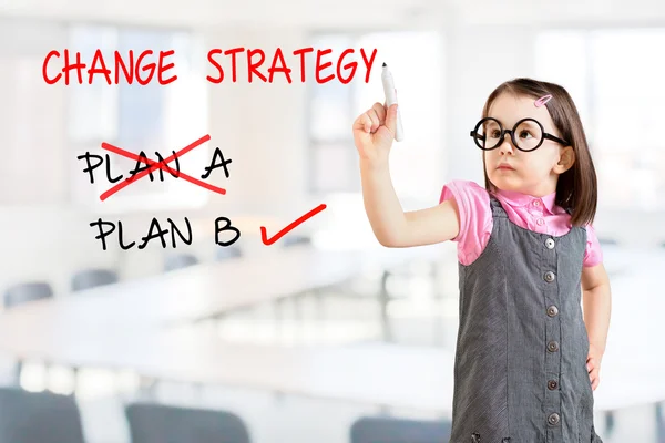 Cute little girl wearing business dress and drawing business plan strategy changing. Office background. — Stock Photo, Image