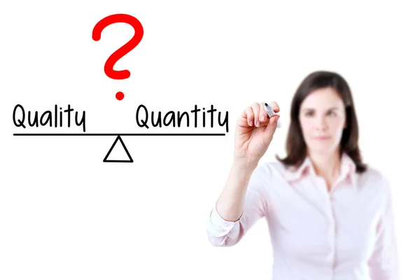 Young business woman writing quality and quantity compare on balance bar. — Stock Photo, Image