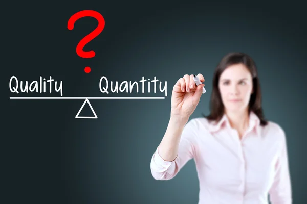 Jonge zakenvrouw schrijven kwaliteit en kwantiteit vergelijken op evenwicht balk. — Stockfoto