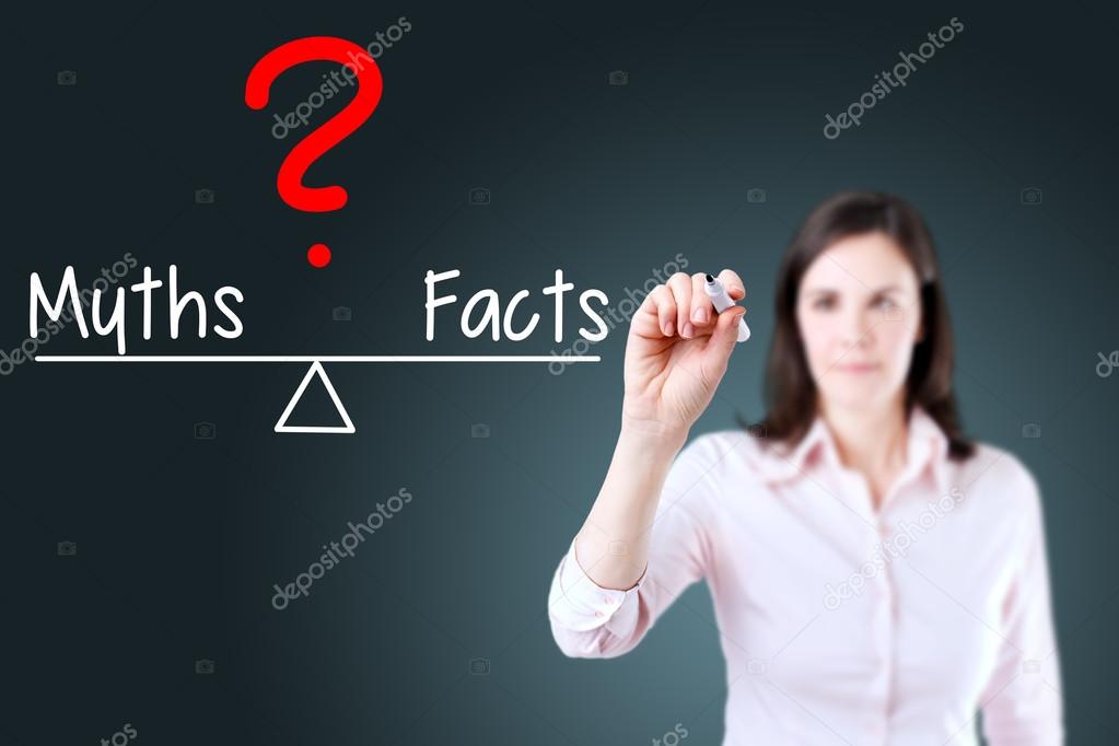 Young business woman writing myths and facts compare on balance bar.