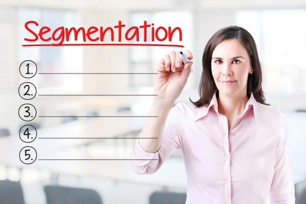 Business woman writing blank Segmentation list. Office background. — Stock Photo, Image