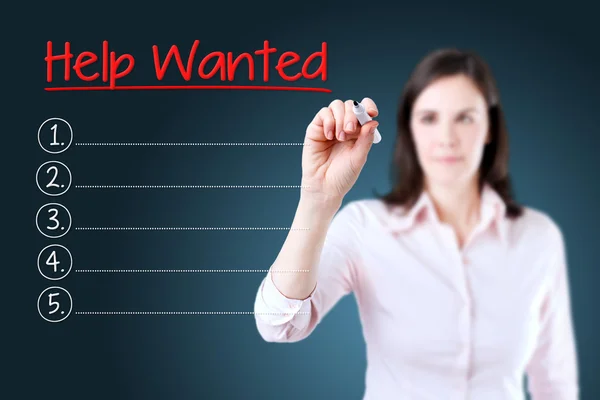 Business woman writing blank Help Wanted list. Blue background. — Stock Photo, Image