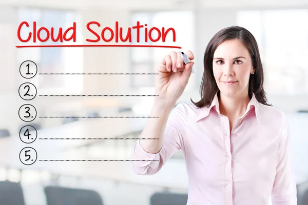 Business woman writing blank Cloud Solutions list.Office background. — Stock Photo, Image