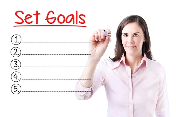 Mulher de negócios escrevendo em branco Set Goals list. Isolado em branco . — Fotografia de Stock