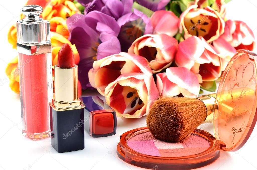 Women's decorative cosmetics rouge, lipstick, flowers and tulips on a white background