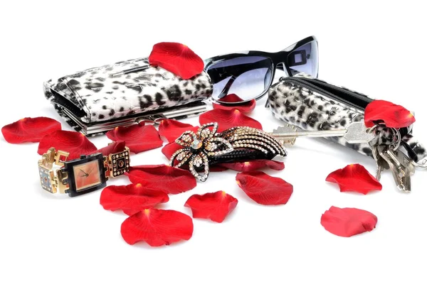 A Red rose petals, women's accessory Handbag for keys, sunglasses, wallet, watch. in still life