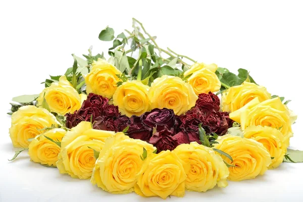 Beautiful bouquet of yellow roses with orange-pink center in the shape of heart — Stock Photo, Image