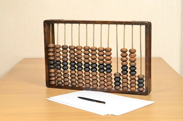 Abacus de madeira antigo de contadores na mesa, folhas de papel e uma caneta em vida morta — Fotografia de Stock