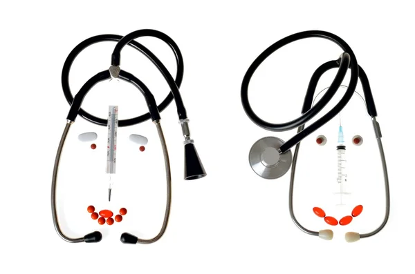Humoristische karikaturen van artsen gemaakt van een medische stethoscoop, tabletten, spuiten, thermometer Stockafbeelding