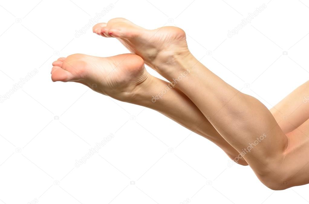 Legs woman which lies on her knees to toe and soles on a white background