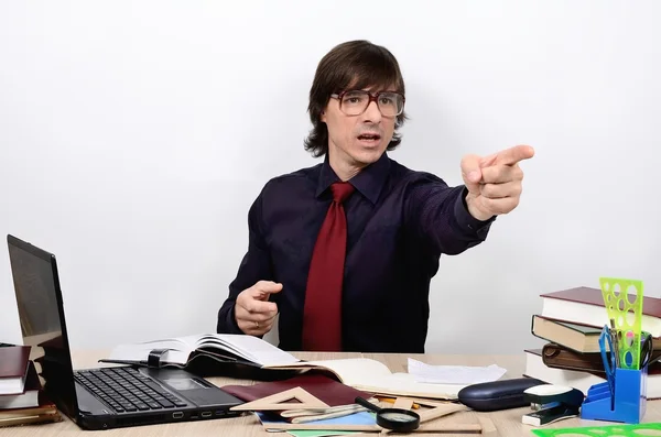 Professor male teacher with glasses at a table requires hand shows thumb — Stock Photo, Image