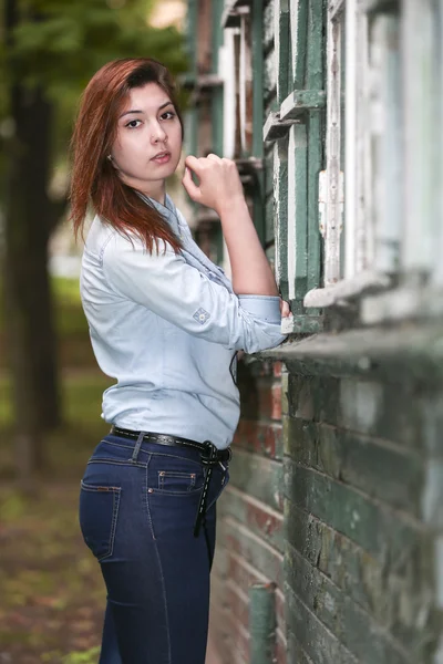 Girl student about an abandoned house in the Park after school. — Stock Photo, Image