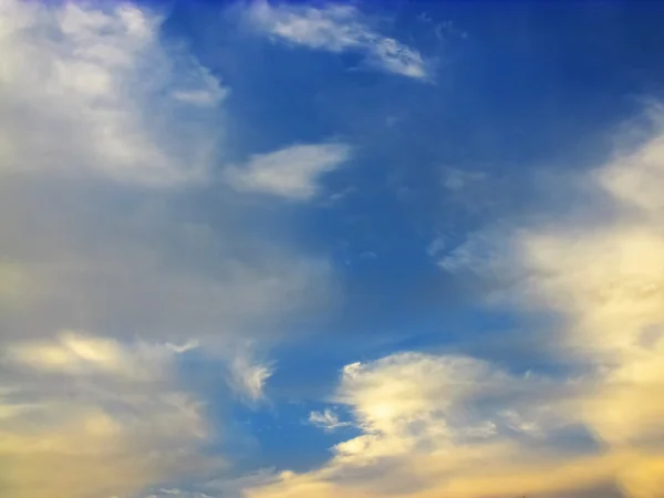 Blauer Himmel mit goldfarbenen Wolken — Stockfoto