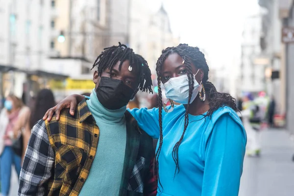 Black couple in the city. With masks.