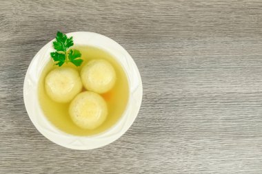 Matzah balls in a bowl of soup clipart
