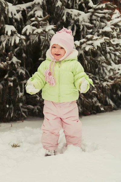 Funny little girl having fun in beautiful winter park during — Stock Photo, Image