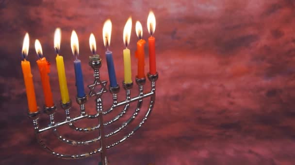 Jewish holiday hannukah symbols - menorah and wooden dreidels. — Stock Video