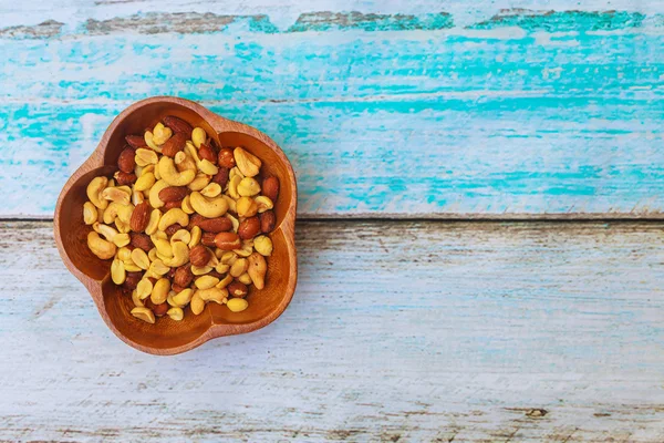 Mix nuts - walnuts, hazelnuts, almonds on a wooden table — Stock Photo, Image