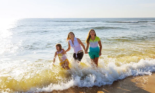 Mother with two daughters on the beach Stock Image