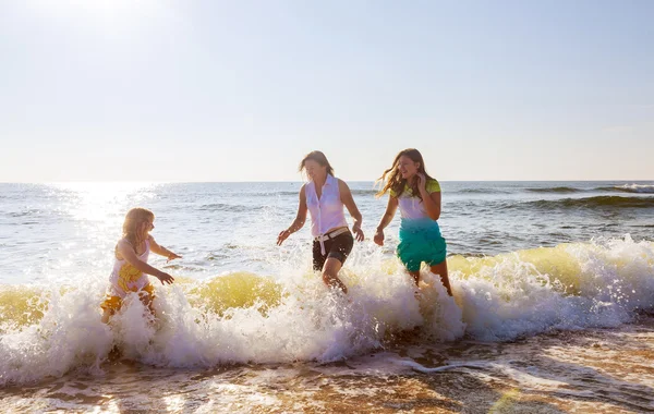 Mother with two daughters on the beach Stock Picture