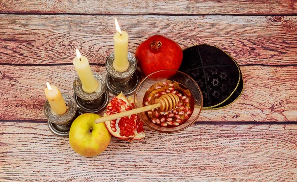 Rosh hashanah jewesh holiday torah book, honey, apple and pomegranate over wooden table. traditional  symbols. Stock Picture