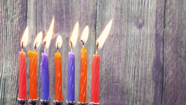 Hanukkah Candles, Jewish Holidays (traditional Candelabra), donuts and wooden dreidels (spinning top). — Stock Video