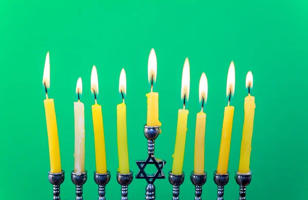 Hanukkah menorah with candles green background isolation — Stock Photo, Image