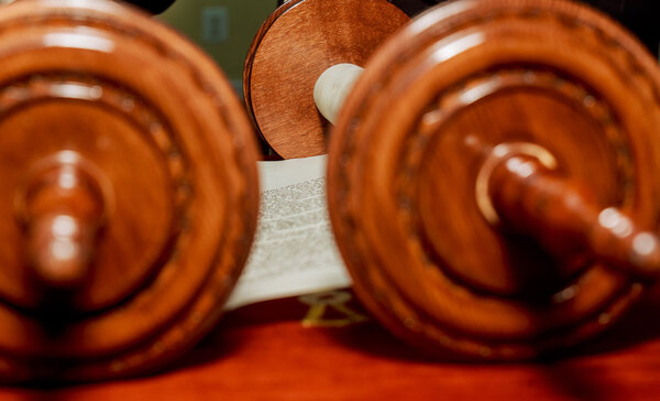 Hand of boy reading the Jewish Torah at Bar Mitzvah