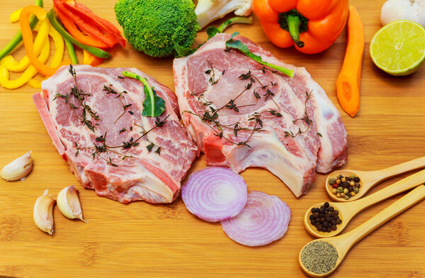 Raw meat steaks with spices cutting board.
