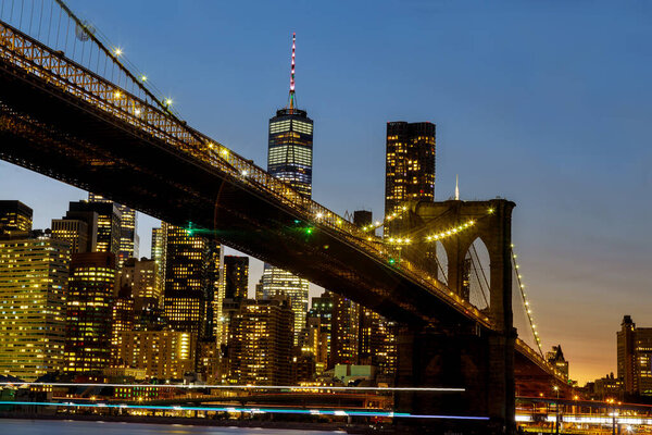 Brooklyn Bridge and Manhattan over East River at sunset, New York USA