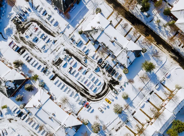 Aerial view apartment buildings complex in residential home neighborhood roof houses covered snow