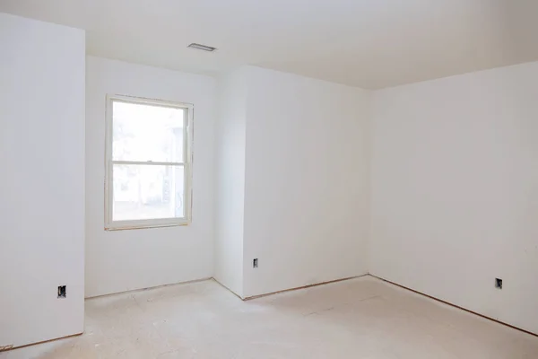 Interior construction of housing of empty apartment with white wall