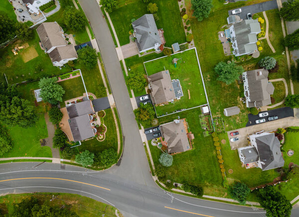 Landscape scenic aerial view of a suburban settlement in USA with detached houses