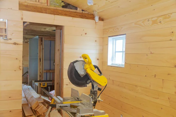 Wooden wall and ceiling in a private house on construction remodeling home with close up of circular saw cutting wood