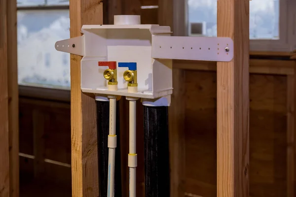 Water system at home on installation of a laundry outlet boxes in a new house for connection of water to the washing machine — Stock Photo, Image