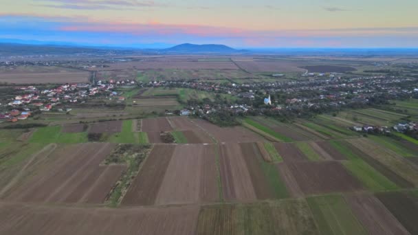 Dron widok z lotu ptaka jesiennych pól z wiejskimi domkami rolniczymi wokół małej wioski piękny krajobraz — Wideo stockowe