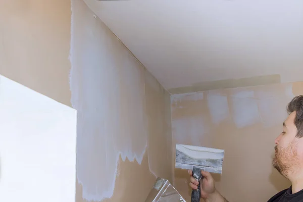 Plastering wall coating putty plaster on the wall on home interior renovation