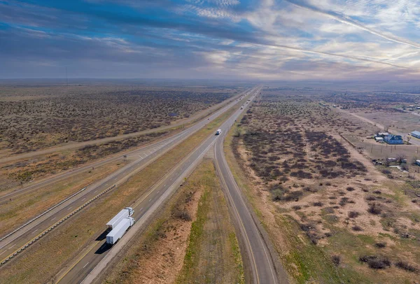 Desert road aerial of a new two lane road surrounded by desert landscape near San Jon New Mexico USA