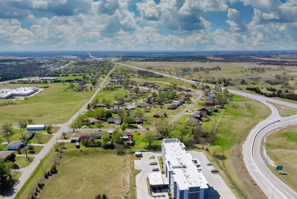Above transport junction road aerial view with car movement transport industry near residential district at suburban development with a Stroud Oklahoma USA