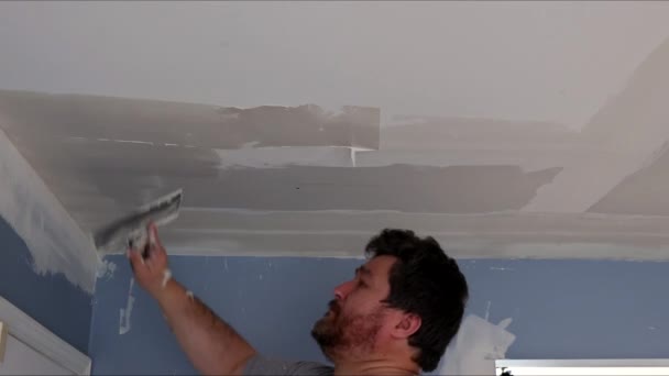 Travailleur de la construction professionnelle appliquant un revêtement de plâtre au plafond le panneau de plâtre fraîchement — Video