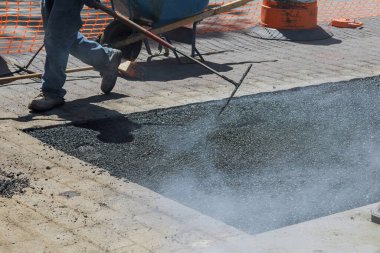 Yeni asfalt rekonstrüksiyonlu yol işçilerin asfalt kaplamasında.