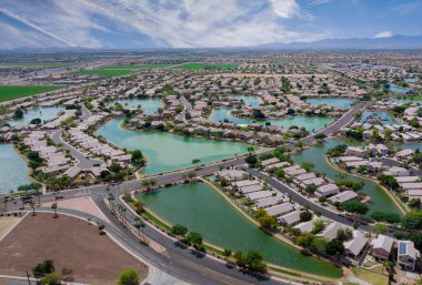Aerial roofs of the many small ponds near a Avondale town houses in the urban landscape of a small sleeping area Phoenix Arizona USA clipart