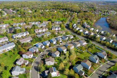 Aerial view of small american town residential houses neighborhood complex at suburban housing development clipart