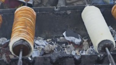 Çek Cumhuriyeti Prag 'da sokak pazarındaki turistler arasında Trdelnik pastanesinde popüler yemek