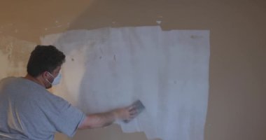 Alçıpanı alçıpanla zımparalıyor.