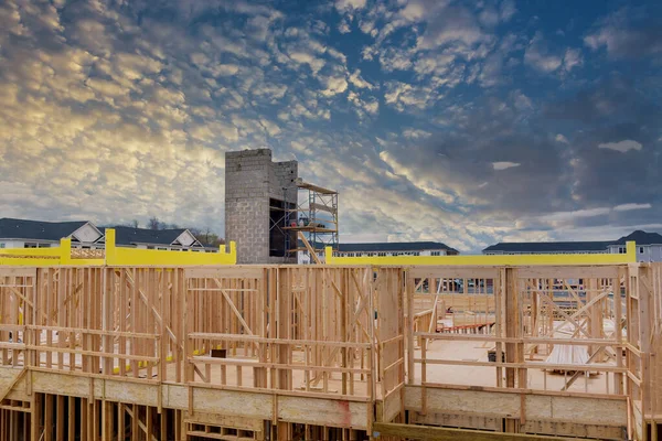 Aerial view of elevator shaft for concrete block building under construction work on workers are laying blocks the a beams house residential under construction